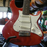 Quality strat copy with powersound pickups, smooth satin neck, beveled neck heel, and lovely scarlet red finish.
